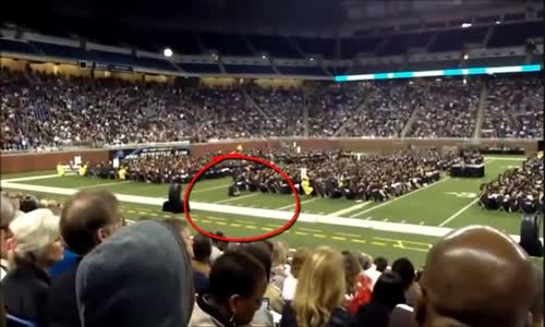 Student Prays at College Graduation