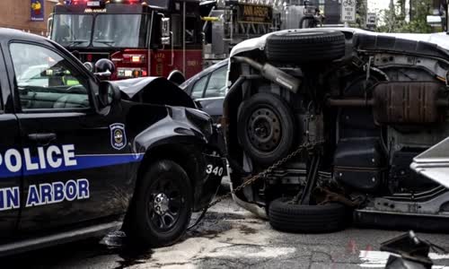 Cop runs red light and causes rollover crash 