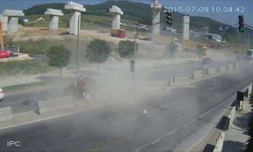 Car gets crushed between cement barriers and truck 