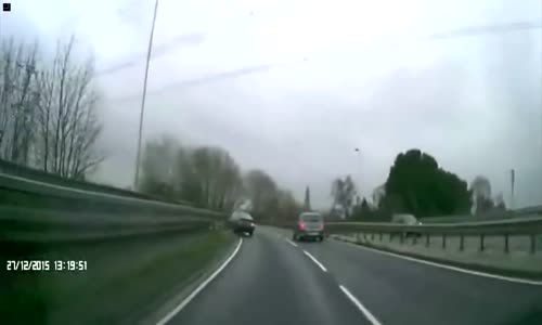 BMW flipping over barrier into oncoming traffic 