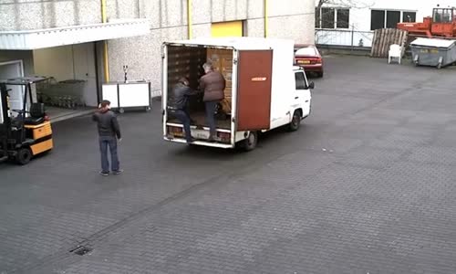 Workers Drop Cases of Beer from Truck 